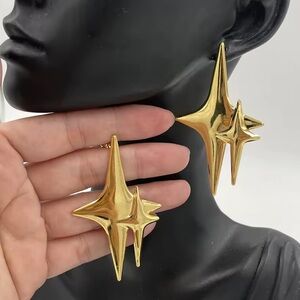 Large star earrings statement